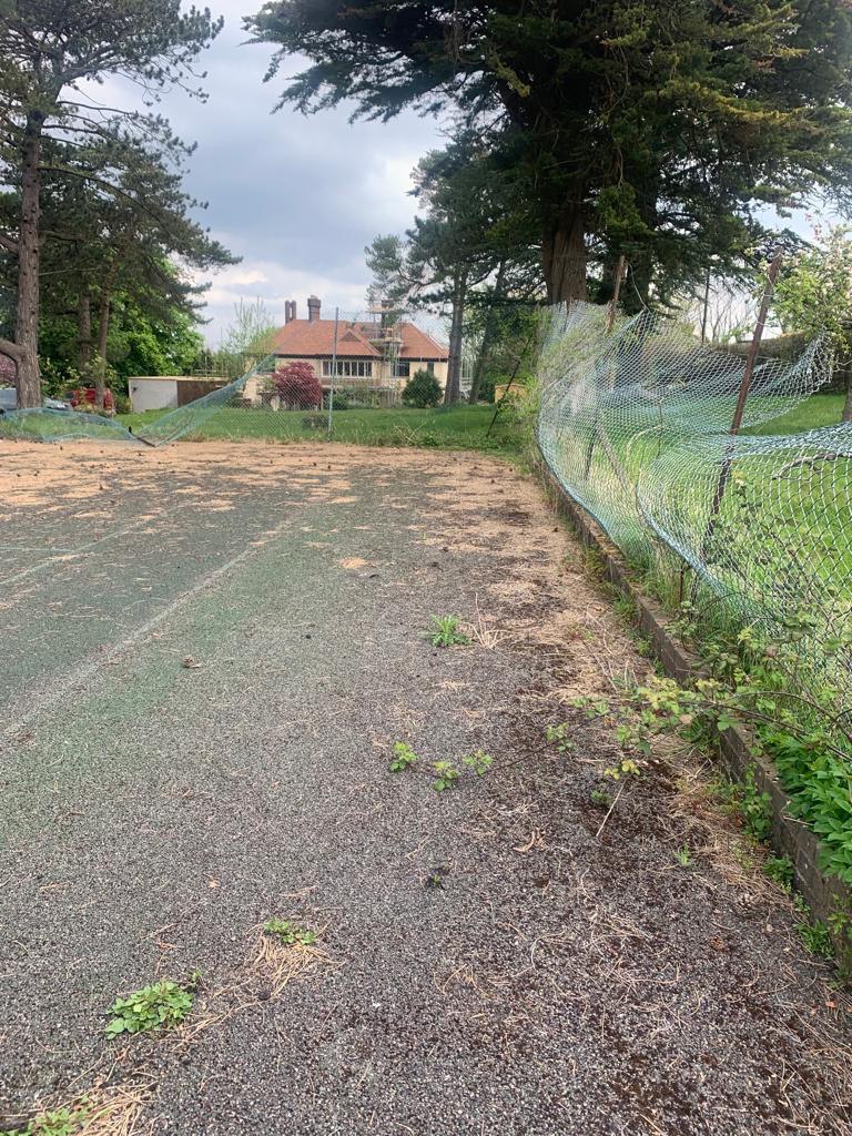 This is a photo of a tennis court in Dorset that is in need of refurbishment